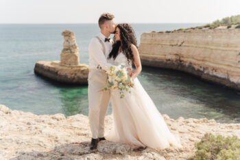 Luxury wedding photography in Algarve & Europe. Elegant, emotional storytelling by Olga & Igor Rosi. Full-day, elopement & destination packages available. Luxury wedding photography and videography in Algarve & Europe. Algarve clifftop wedding venue. Elegant, emotional storytelling by Olga & Igor Rosi, Algarve Pictures. Full-day, elopement & destination packages available. Bride and groom portrait at sunset with dramatic cliffs and ocean in Carvoeiro.