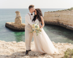 Luxury wedding photography in Algarve & Europe. Elegant, emotional storytelling by Olga & Igor Rosi. Full-day, elopement & destination packages available. Luxury wedding photography and videography in Algarve & Europe. Algarve clifftop wedding venue. Elegant, emotional storytelling by Olga & Igor Rosi, Algarve Pictures. Full-day, elopement & destination packages available. Bride and groom portrait at sunset with dramatic cliffs and ocean in Carvoeiro.