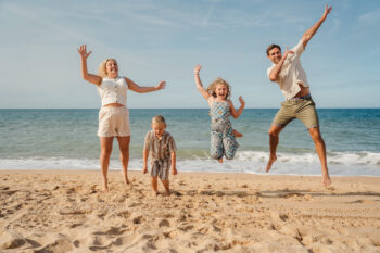 Family playing on the beach in Algarve